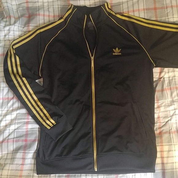 black adidas track jacket with gold stripes